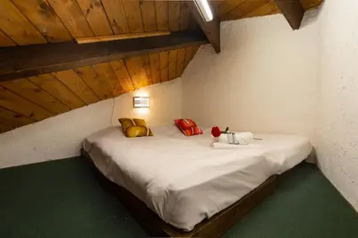 a bed in a room with pillows on it at Résidence Grand Roc - Bruyères 441 - Happy Rentals in Chamonix-Mont-Blanc