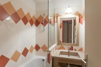 a bathroom with a sink and a mirror at Résidence Pierre & Vacances Le Chamois Blanc in Chamonix-Mont-Blanc