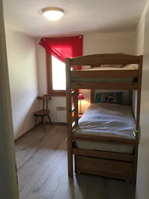 a bedroom with a bunk bed and a window at Appartement face au Mont Blanc & Glaciers in Chamonix-Mont-Blanc