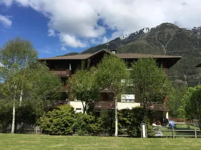 a building with a mountain in the background at Appartement face au Mont Blanc & Glaciers in Chamonix-Mont-Blanc