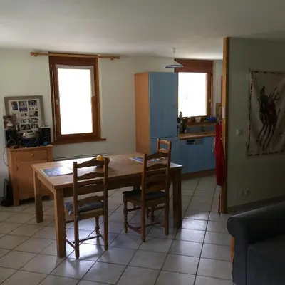 a kitchen with a wooden table and chairs at Appartement face au Mont Blanc & Glaciers in Chamonix-Mont-Blanc