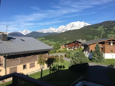 a view of the mountains from a house at Appartement cosy et chaleureux à Megève avec vue sur le Mont Blanc in Demi-Quartier