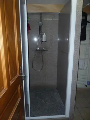 a shower with a glass door in a bathroom at Chalets Pyrene Mont-Blanc in Chamonix-Mont-Blanc
