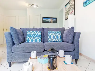 a bedroom with a large bed with a blue headboard at Apartment Les Gentianes by Interhome in Saint-Gervais-les-Bains