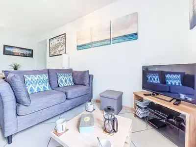 a living room with two couches and a kitchen at Apartment Les Gentianes by Interhome in Saint-Gervais-les-Bains