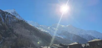 a view of a mountain with the sun in the sky at Appt 4 /5 pers - 3 min. centre ville in Chamonix-Mont-Blanc