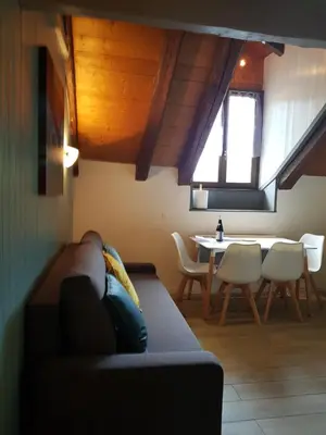 a living room with a couch and a table at Studio Duplex Place de la Grenette in Sallanches