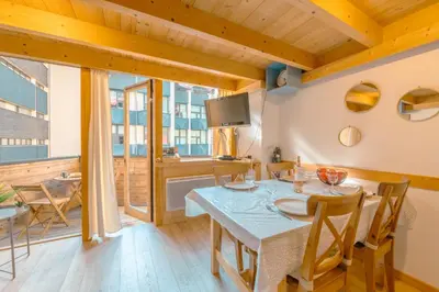 a dining room with a table and chairs at Résidence Grand Roc - Campanules 322 - Happy Rentals in Chamonix-Mont-Blanc