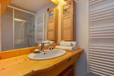 a bathroom with a sink and a mirror at Résidence Grand Roc - Campanules 322 - Happy Rentals in Chamonix-Mont-Blanc