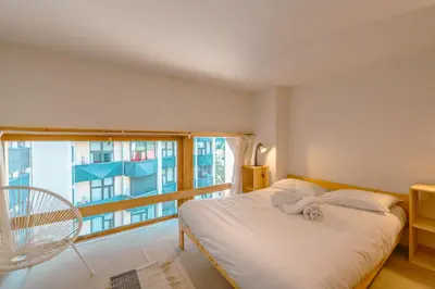 a bedroom with a bed and a large window at Résidence Grand Roc - Campanules 322 - Happy Rentals in Chamonix-Mont-Blanc