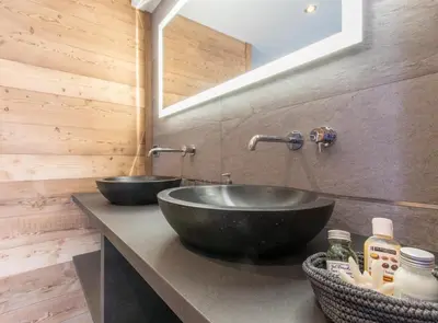 a bathroom with two sinks on a counter at chalet des grands bois in Les Houches