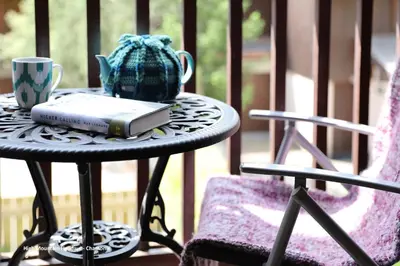 a book on a table with a cup and a mug at Apartment Chloe in Chamonix-Mont-Blanc