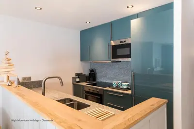 a kitchen with blue cabinets and a sink at Apartment Chloe in Chamonix-Mont-Blanc