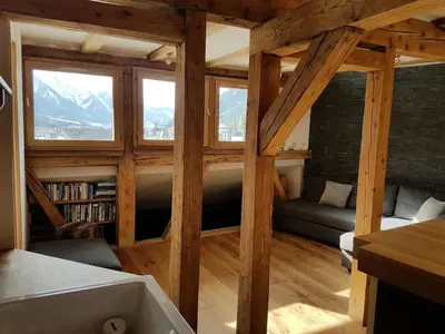 a living room with a large window and a couch at Beautiful apartment in Chamonix centre with superb mountain views in Chamonix-Mont-Blanc
