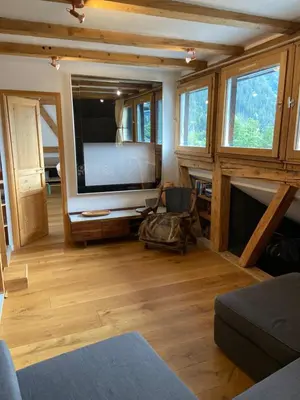 a living room with a large flat screen tv at Beautiful apartment in Chamonix centre with superb mountain views in Chamonix-Mont-Blanc