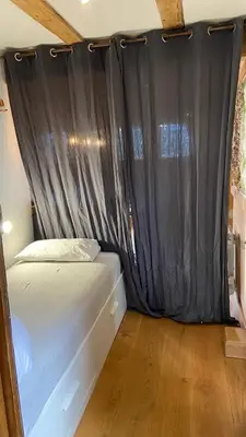 a bedroom with a bed with a black curtain at Beautiful apartment in Chamonix centre with superb mountain views in Chamonix-Mont-Blanc