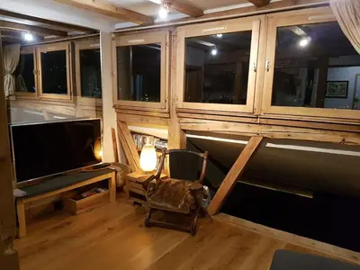 a room with a tv and a chair in a room at Beautiful apartment in Chamonix centre with superb mountain views in Chamonix-Mont-Blanc