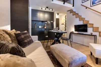 a living room with a couch and a table at Apartment Midi Loft - A Central Chamonix Mountain Haven in Chamonix-Mont-Blanc