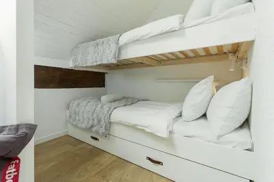 a small bedroom with two bunk beds in it at Apartment Midi Loft - A Central Chamonix Mountain Haven in Chamonix-Mont-Blanc