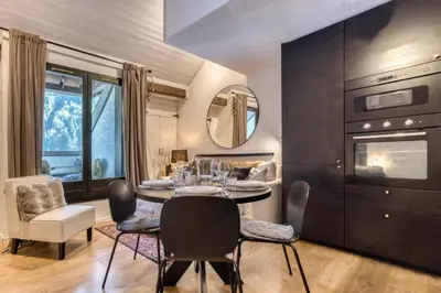 a dining room with a table and chairs at Apartment Midi Loft - A Central Chamonix Mountain Haven in Chamonix-Mont-Blanc