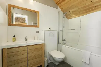 a bathroom with a toilet and a sink and a mirror at Apartment Midi Loft - A Central Chamonix Mountain Haven in Chamonix-Mont-Blanc