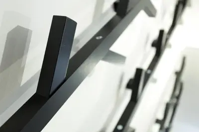 a row of black objects on a wall at Apartment Midi Loft - A Central Chamonix Mountain Haven in Chamonix-Mont-Blanc