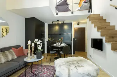 a living room with a couch and a table at Apartment Midi Loft - A Central Chamonix Mountain Haven in Chamonix-Mont-Blanc