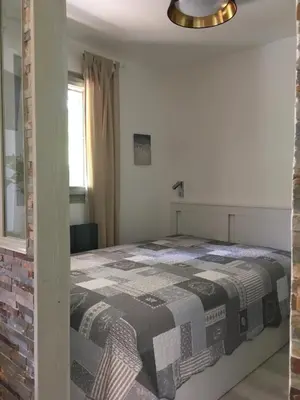 a bedroom with a bed with a checkered blanket at les Cimes d'Or Mont blanc in Les Contamines-Montjoie