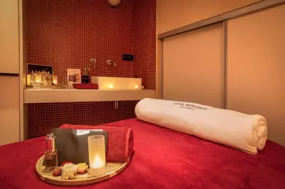 a room with a bed with a pillow and candles on a table at Chalet Hôtel Le Prieuré & Spa in Chamonix-Mont-Blanc