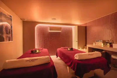 a room with two beds with towels on them at Chalet Hôtel Le Prieuré & Spa in Chamonix-Mont-Blanc