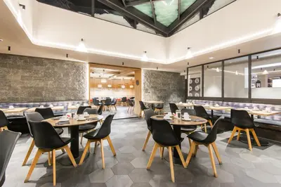 a restaurant with tables and chairs in a room at Chalet Hôtel Le Prieuré & Spa in Chamonix-Mont-Blanc