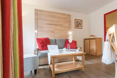 a dining room and living room with a table and chairs at Résidence Pierre & Vacances La Rivière in Chamonix-Mont-Blanc