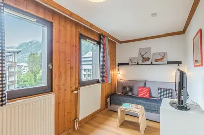 a living room with a couch and a table at Résidence Pierre & Vacances La Rivière in Chamonix-Mont-Blanc