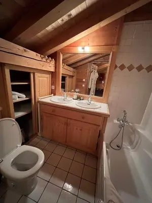 a table with two cups and a phone on it at Chambres et Mazots du Chalet de Mado in Megève