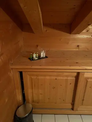 a bathroom with a white sink in a wooden room at Chambres et Mazots du Chalet de Mado in Megève