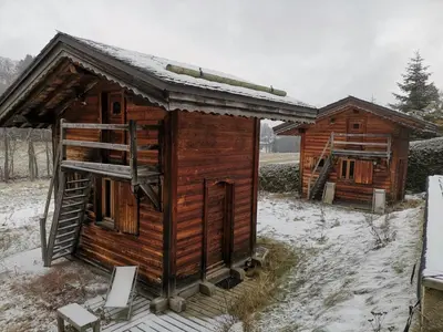 a small out house sitting on top of a field at Chambres et Mazots du Chalet de Mado in Megève