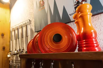 a row of orange and red items on a shelf at Apartment Vila 1 - Cosy Central Chamonix Loft in Chamonix-Mont-Blanc