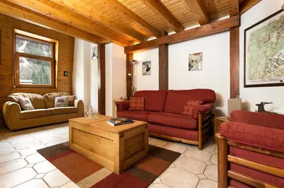 a living room with two red couches and a table at Apartment Vila 1 - Cosy Central Chamonix Loft in Chamonix-Mont-Blanc