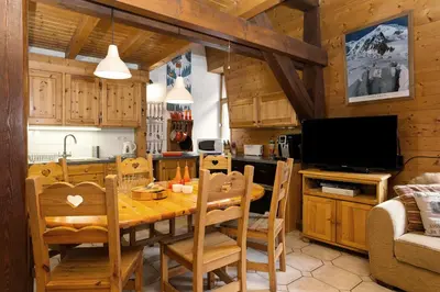a kitchen and dining room with a wooden table and chairs at Apartment Vila 1 - Cosy Central Chamonix Loft in Chamonix-Mont-Blanc