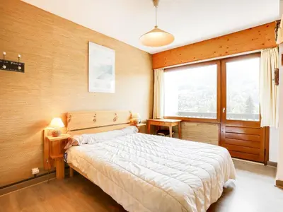 a bedroom with a bed and a large window at Apartment Le Sarto by Interhome in Saint-Gervais-les-Bains