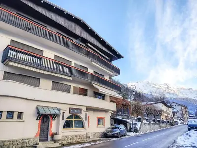 a building on the side of a street in the snow at Apartment Le Sarto by Interhome in Saint-Gervais-les-Bains