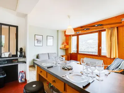 a dining room with a table with wine glasses on it at Apartment Le Sarto by Interhome in Saint-Gervais-les-Bains