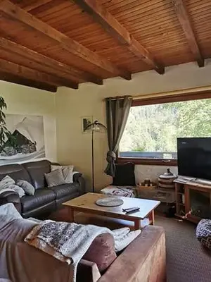 a living room with a couch and a table at La Gelinotte in Les Contamines-Montjoie