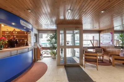 a restaurant lobby with a bar and a dining area at maeva Home Résidence la Rivière in Chamonix-Mont-Blanc
