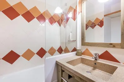 a bathroom with a sink and a mirror at maeva Home Résidence la Rivière in Chamonix-Mont-Blanc
