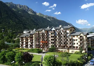 a hotel in the mountains with mountains in the background at maeva Home Résidence la Rivière in Chamonix-Mont-Blanc