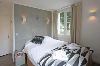 a bedroom with a bed with two towels on it at La Saleina Apartment - Chamonix All Year in Chamonix-Mont-Blanc