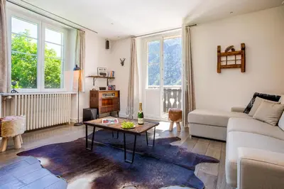 a living room with a couch and a table at La Saleina Apartment - Chamonix All Year in Chamonix-Mont-Blanc