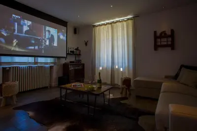 a living room with a couch and a large tv at La Saleina Apartment - Chamonix All Year in Chamonix-Mont-Blanc