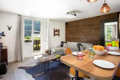 a living room with a table and a couch at La Saleina Apartment - Chamonix All Year in Chamonix-Mont-Blanc